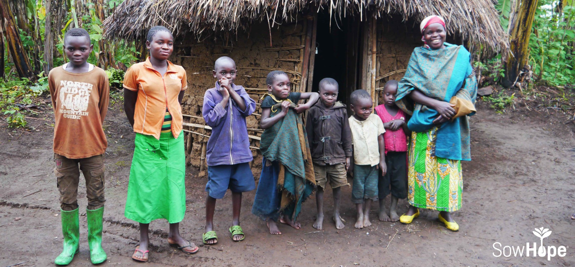 Marie Claire, a mother with her children in Kalonge, DR Congo. This mother is a member of an economic project specifically geared towards helping survivors of armed violence in the region. Photo by Mary Dailey Brown, November 2015.